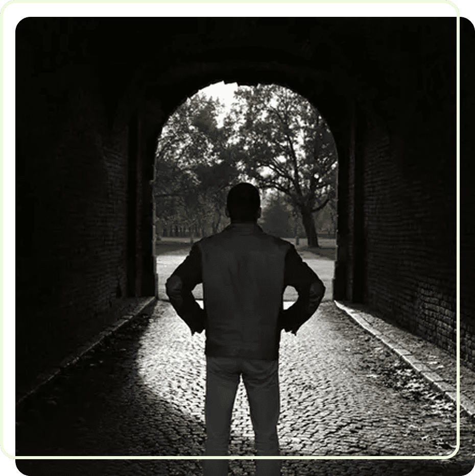Person facing light at tunnel's end